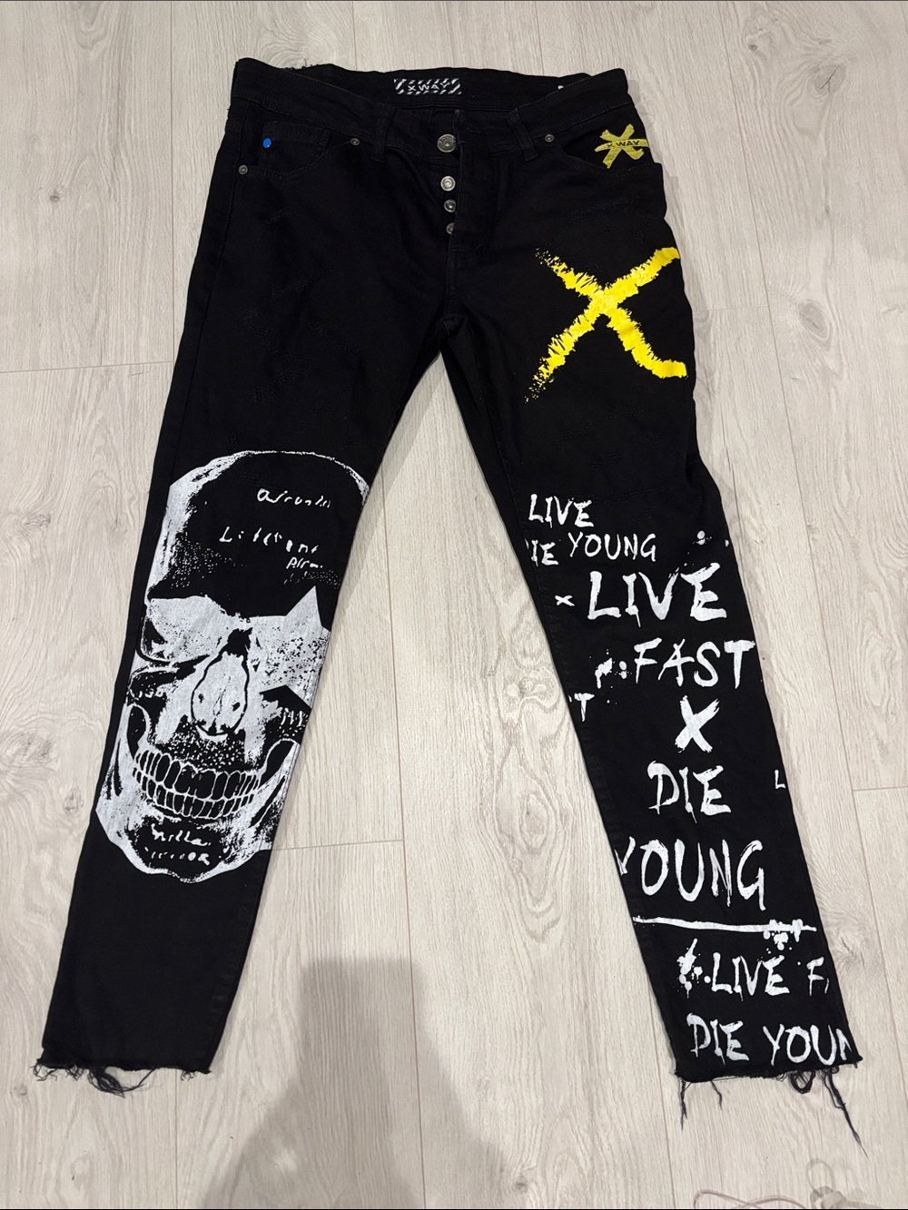 Black Skinny Graphic Jeans with Yellow X Accent